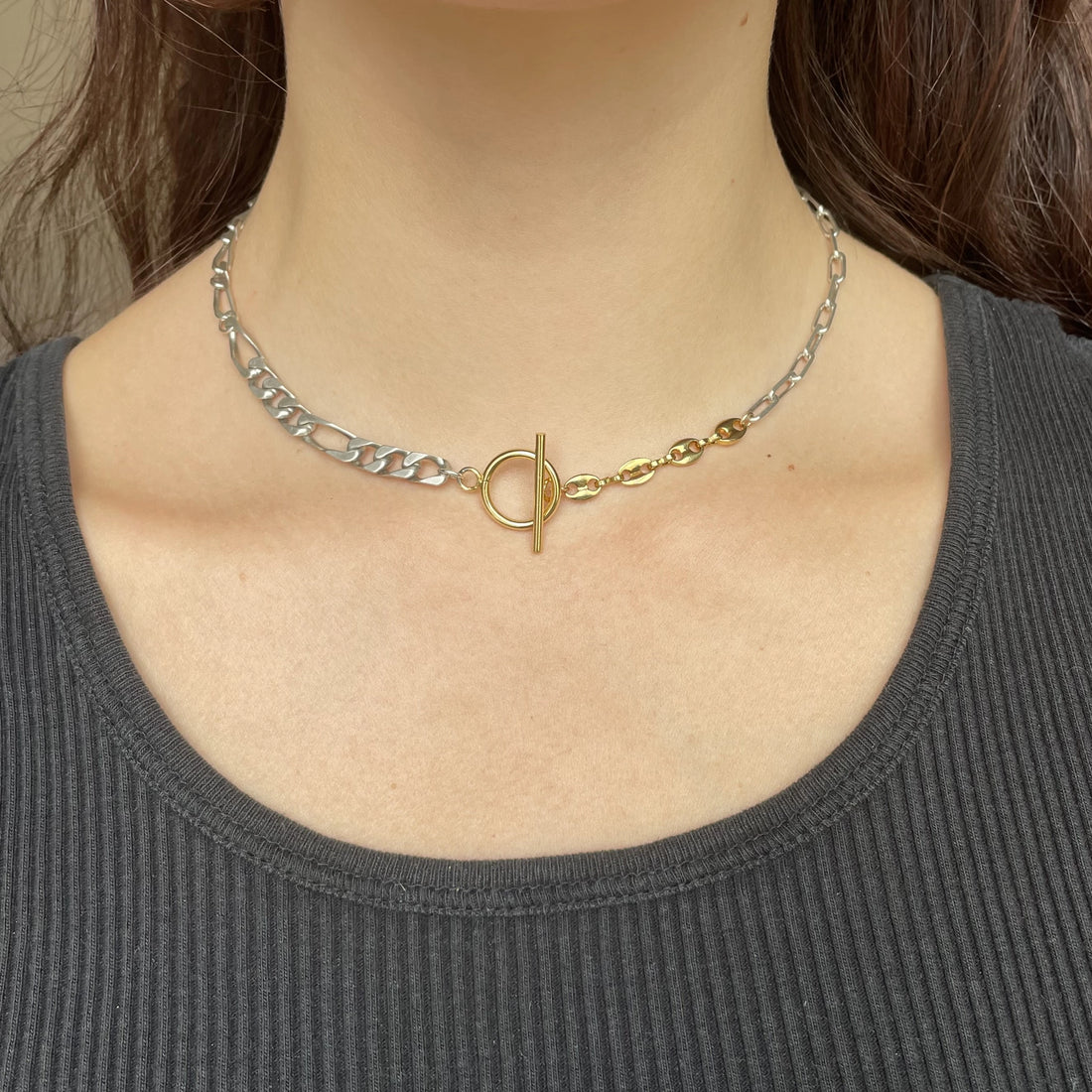 Ce collier est constitué de mailles figaro, gourmette, royale et encore grains de café. Au milieu se trouve le fermoir en T en plaqué or.