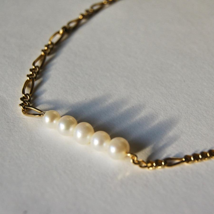 Upcycled asymmetrical necklace adorned with 5 pearls